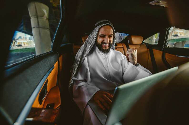 A Jeddah airport taxi waiting outside the terminal, ready for passengers.
