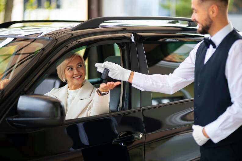 Taxi service transporting passengers from Madinah Airport to their hotel.