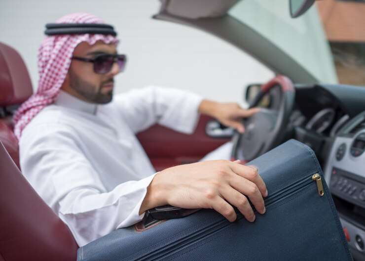 attractive arab man car street