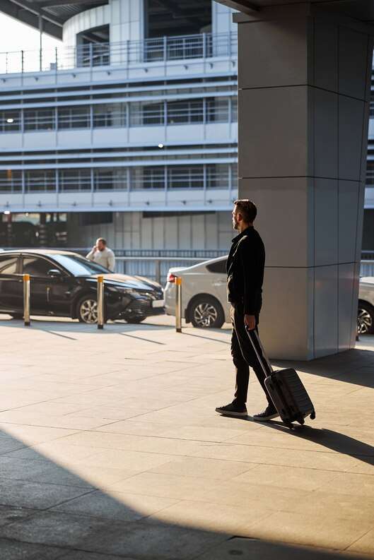 [freepicdownloader com] man casual clothes walking with his luggage medium