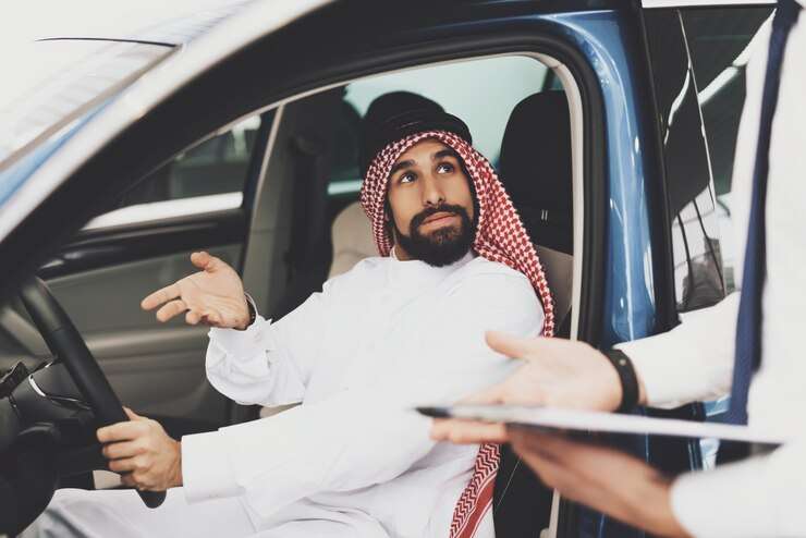 bahraini man dealer choosing vehicle salon